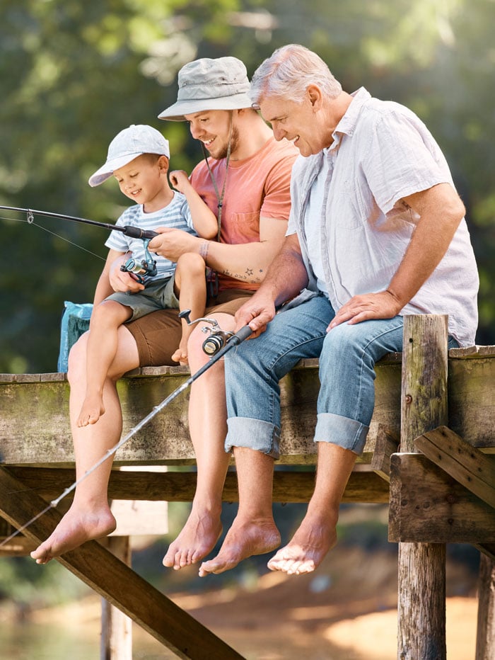 618165748-three-generations-of-males-fishing-on-dock