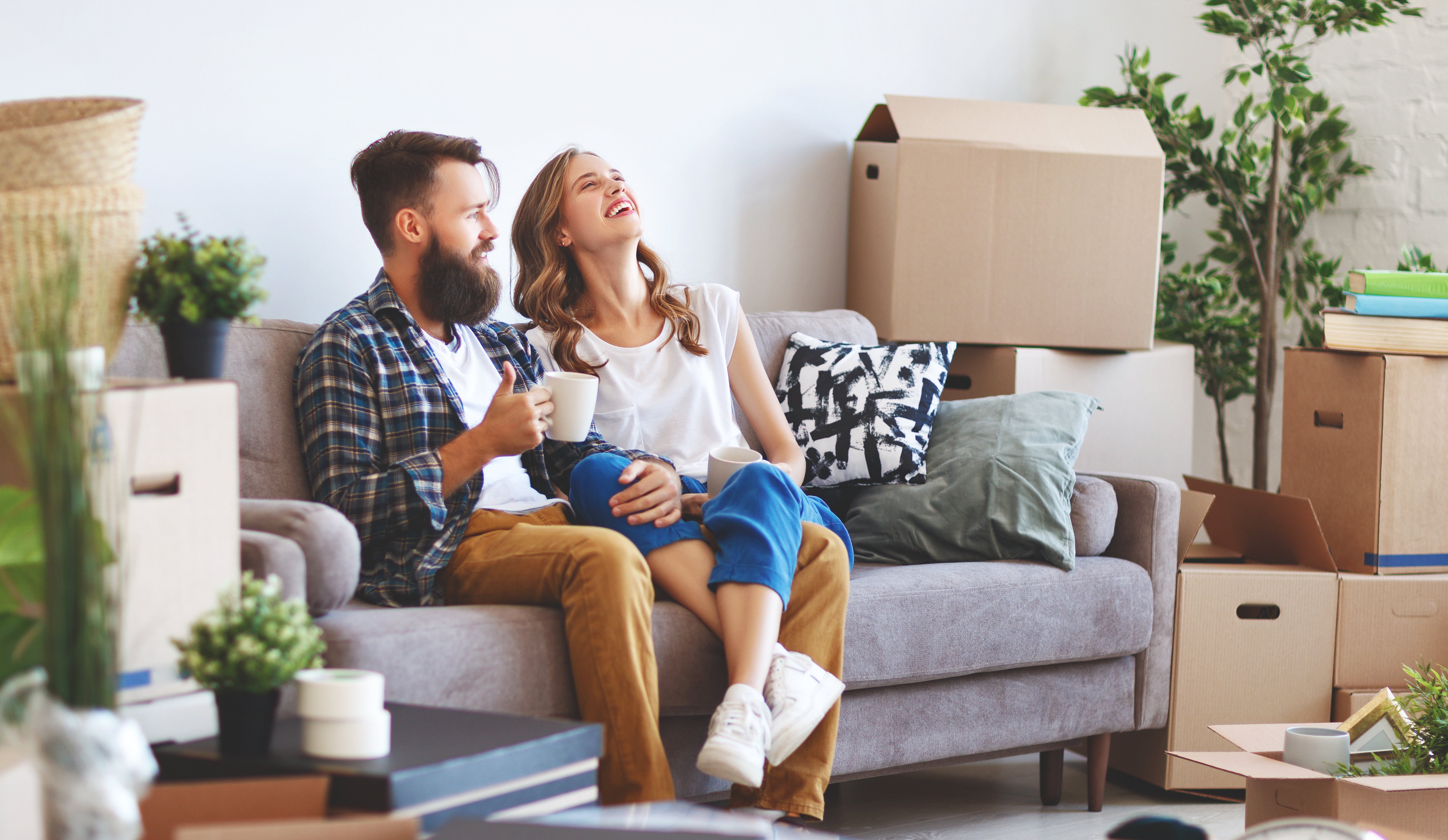 young married couple surrounded by moving boxes